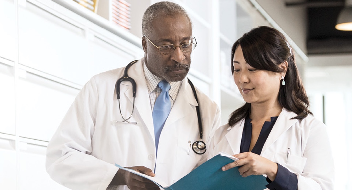 Two doctors reviewing the case of a patient with hepatitis C.